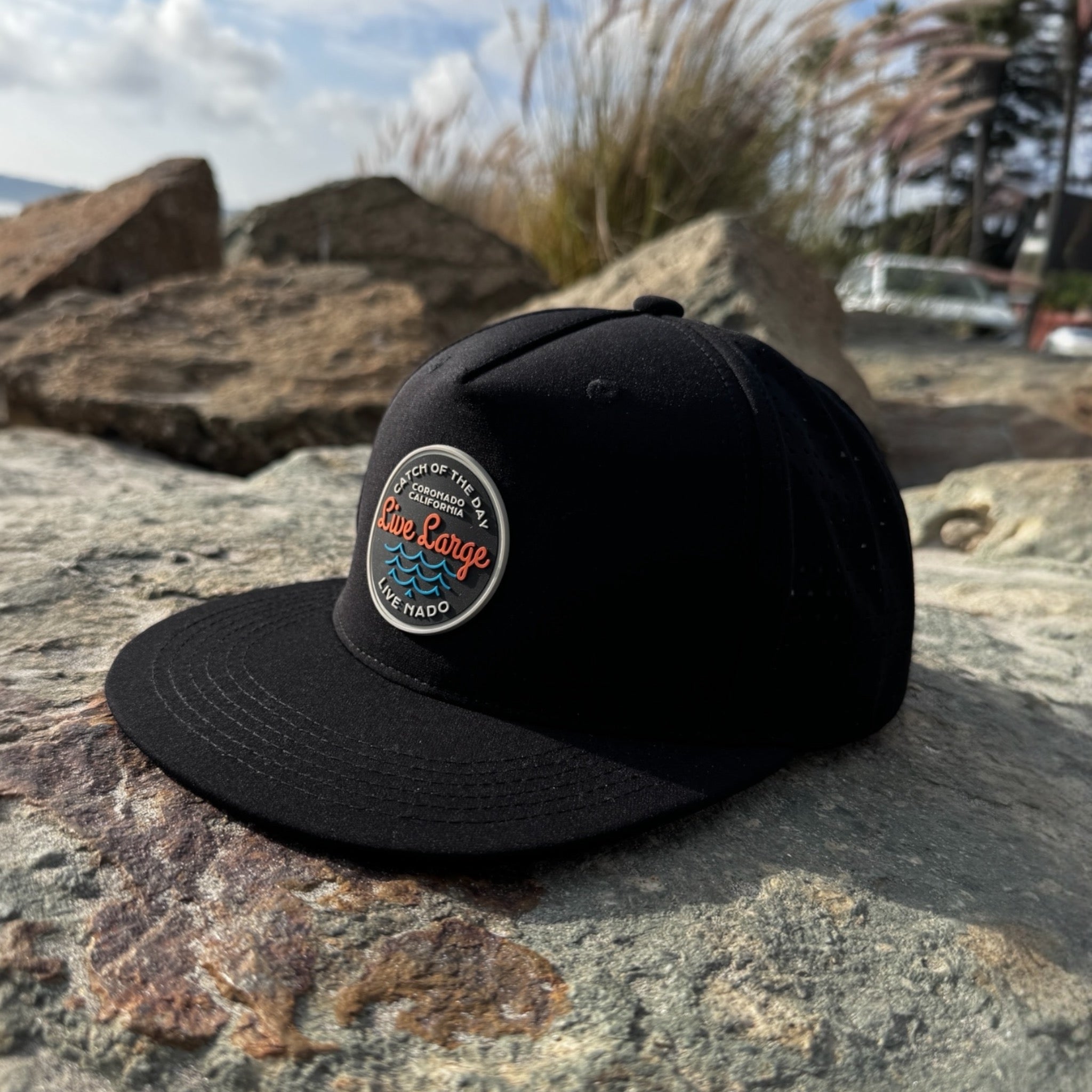 Black water resistant trucker from
Coronado, Ca. 5-panel perforated snap back.