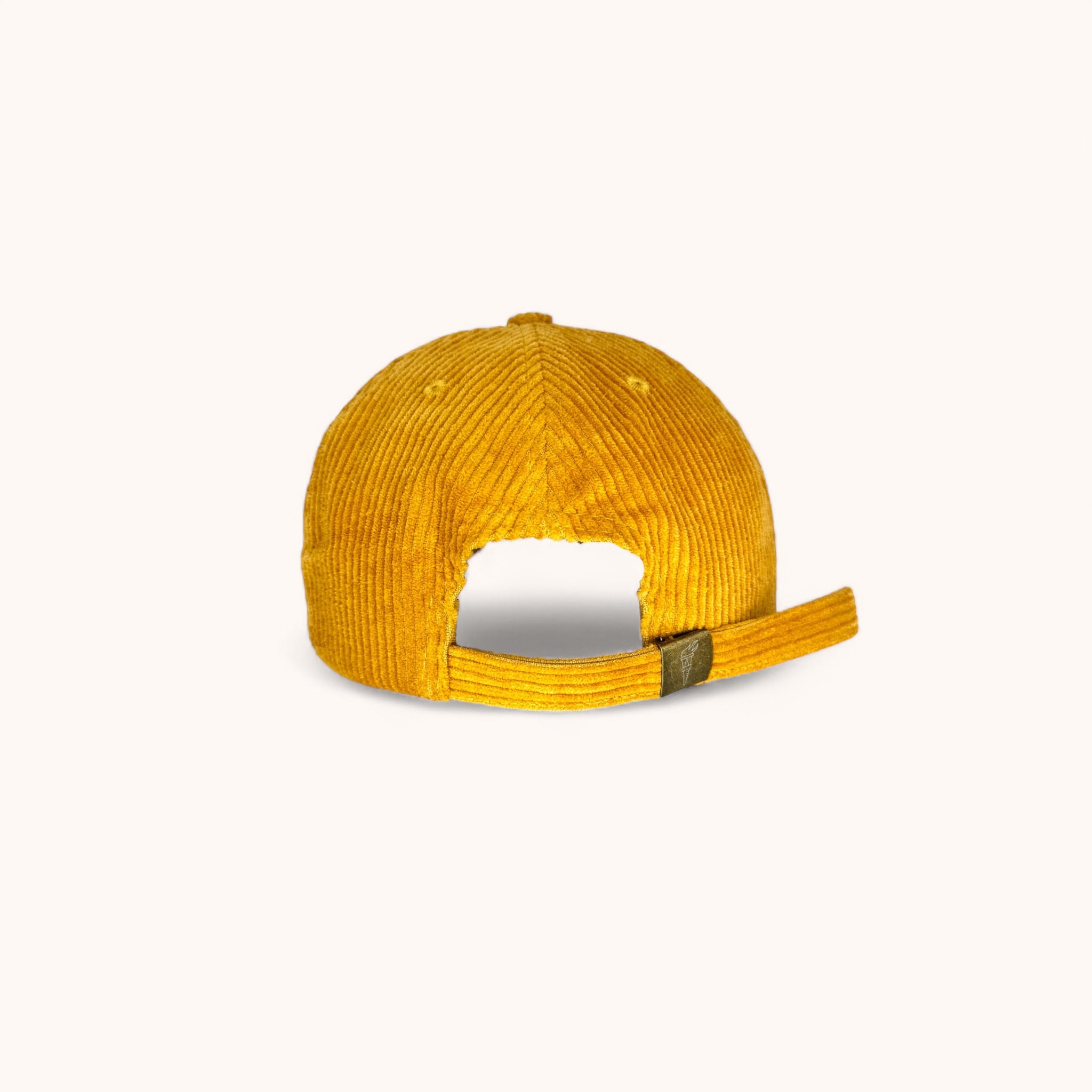 Strap and clasp closure on mustard yellow corduroy surf cap
