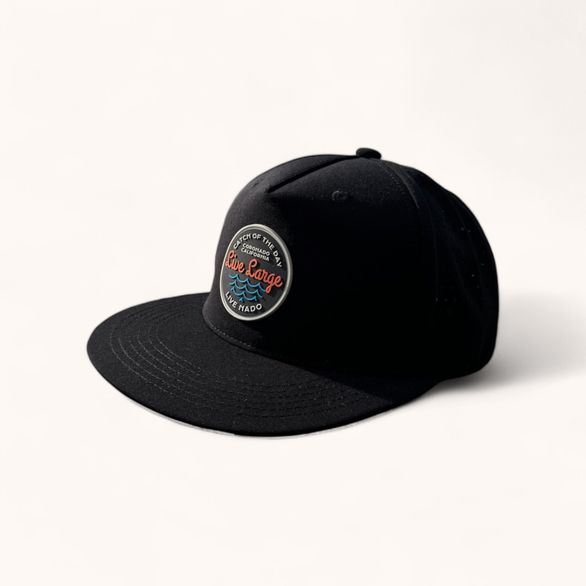 Black perforated back, flat bill trucker, with a Live Large Catch of the Day silicone patch.