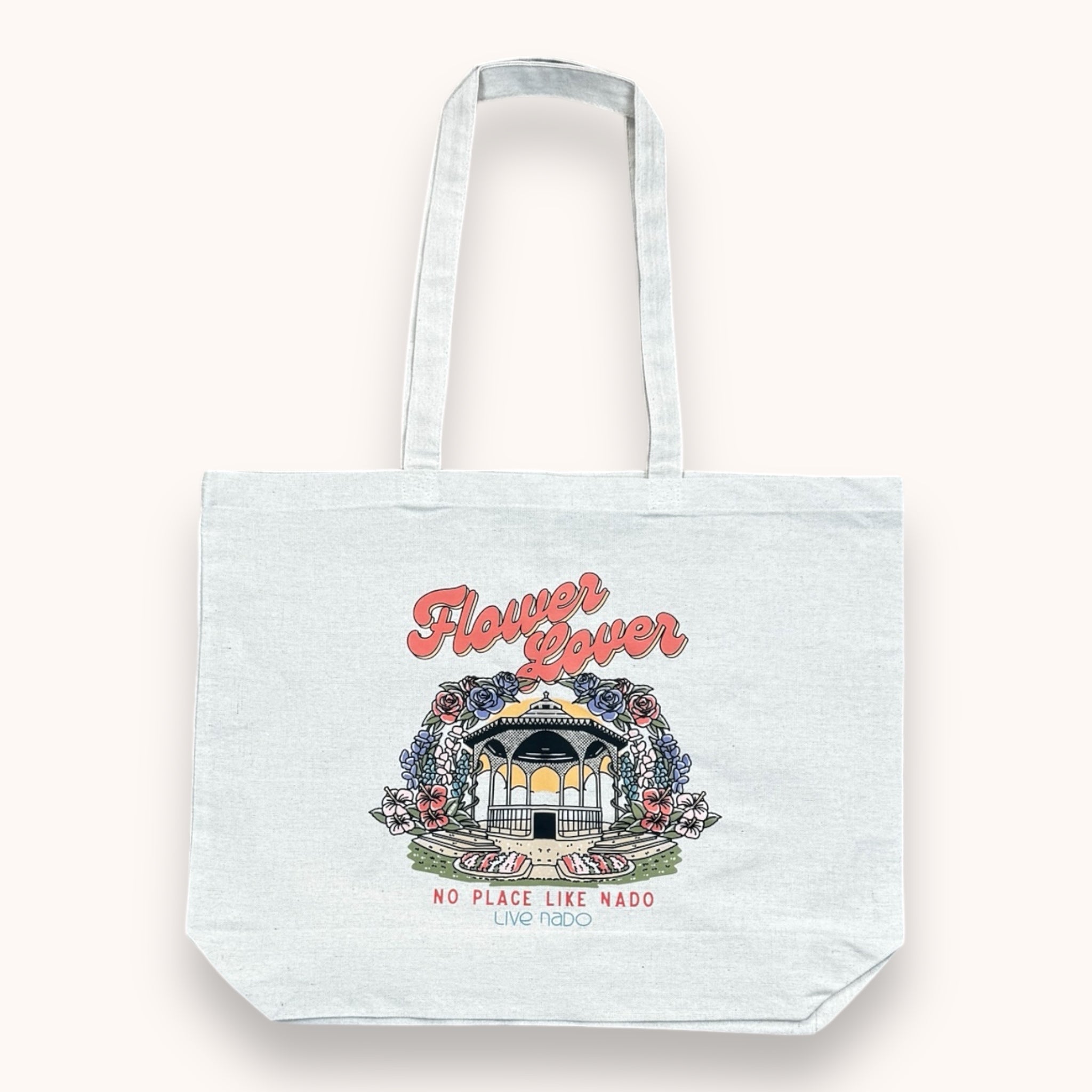 A large white tote bag with a floral-inspired design and text 'Flower Lovers' printed on the front.