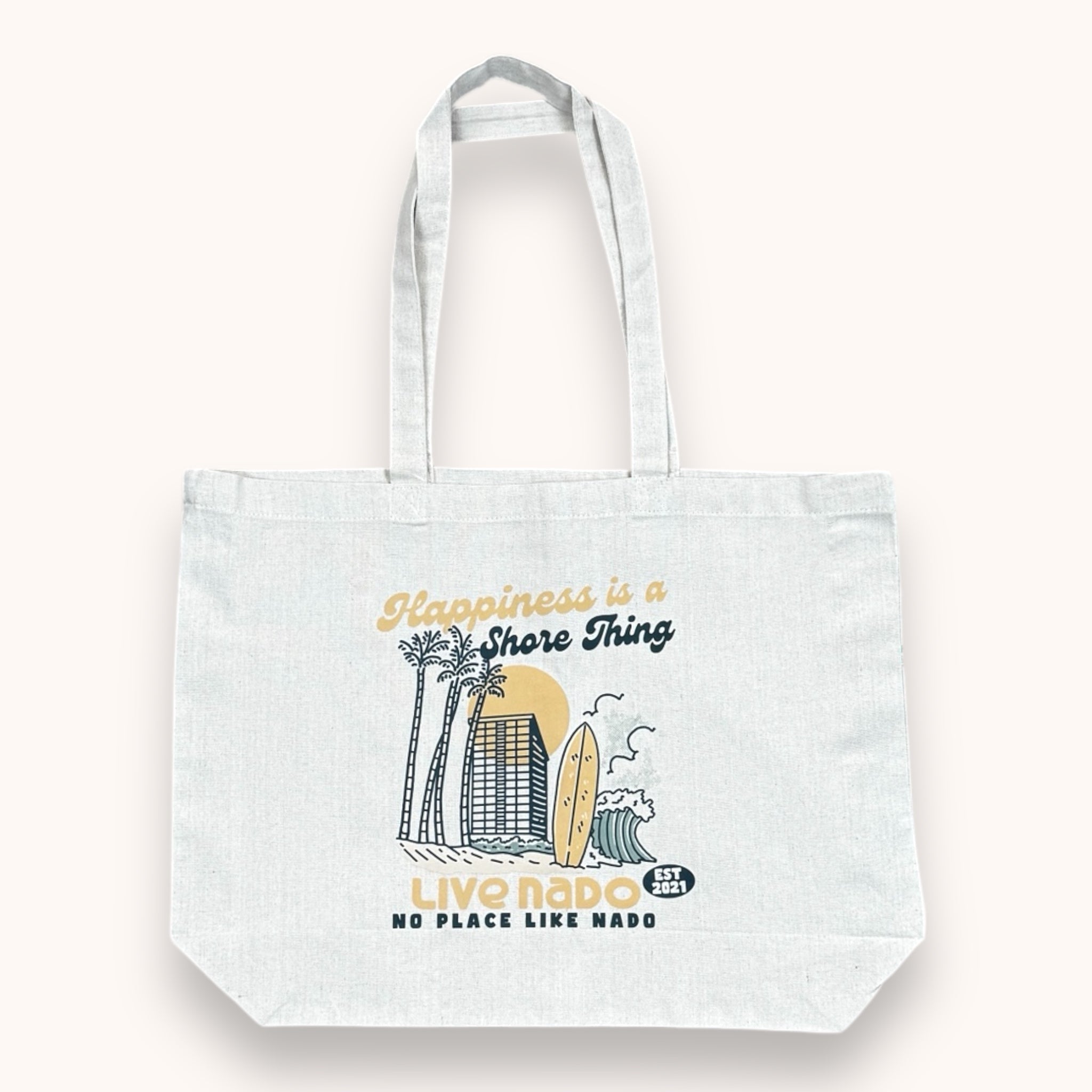 A large white recycled cotton tote bag with a printed design featuring a beach and the text 'Happiness is a Shore Thing. Live Nado.