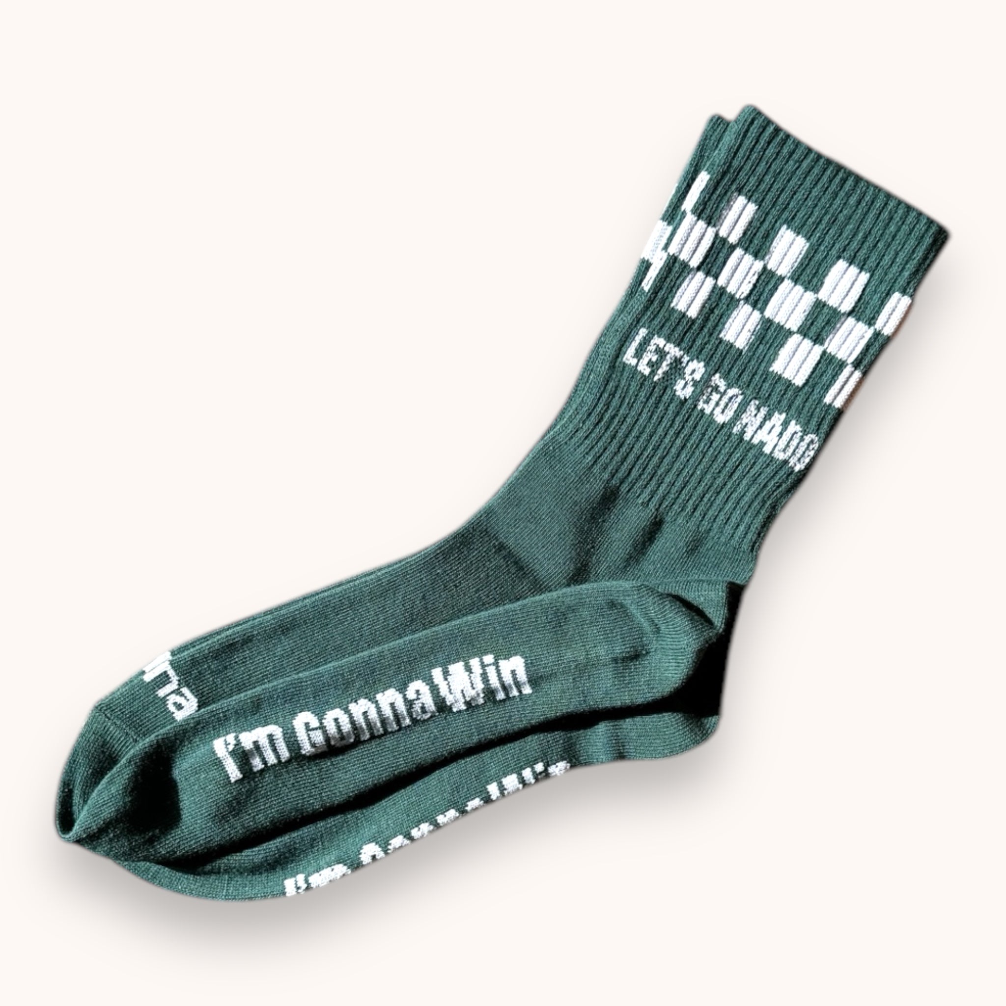 Dark green crew socks with white checkered pattern and text on the cuff, displayed on a white background.