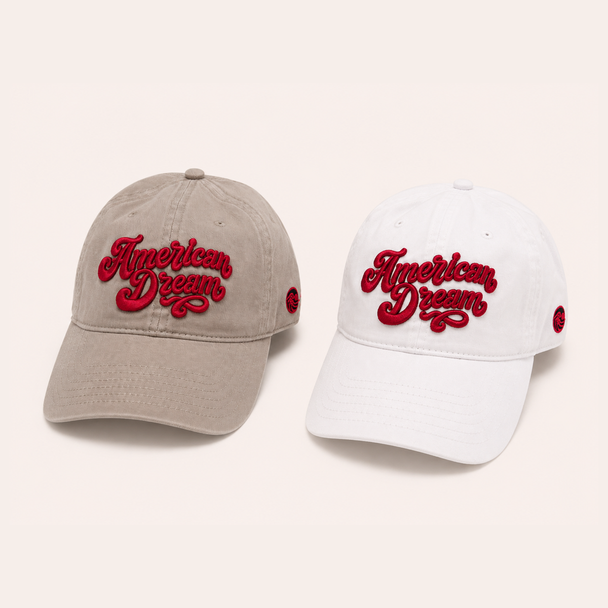 tan and white baseball caps featuring raised red "American Dream" cursive embroidery across the front.