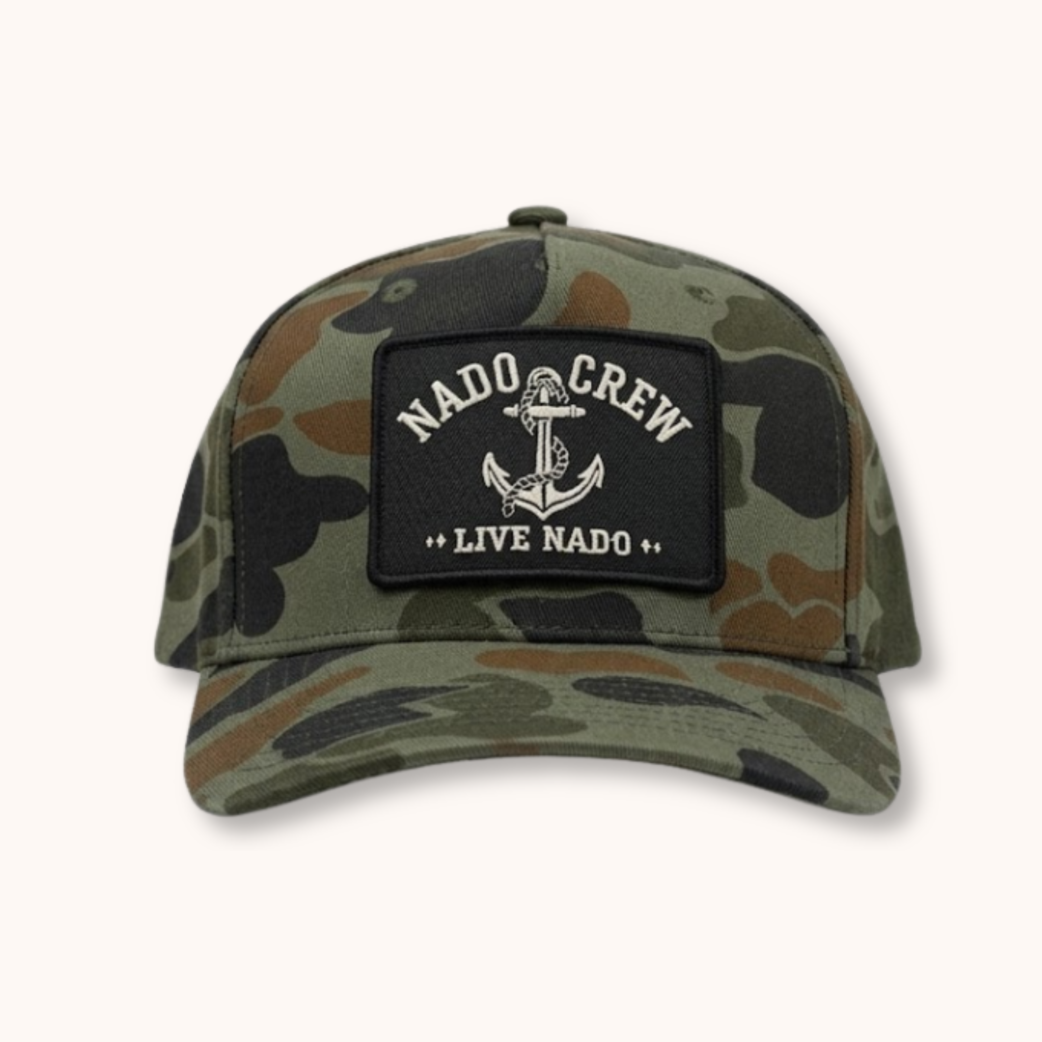 Camouflage cap with a patch labeled 'Nado Crew Live Nado' on a white background