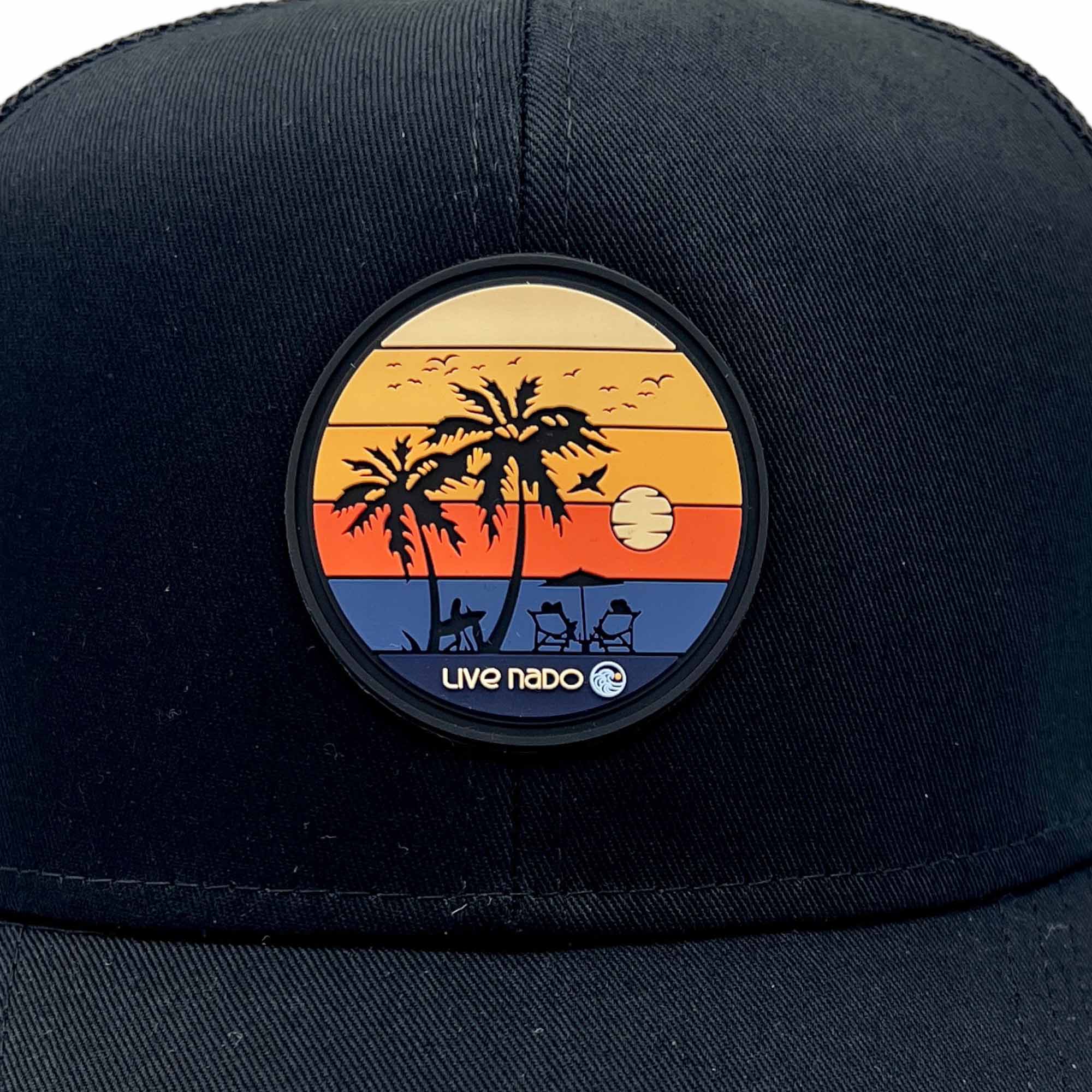 close up of sunset enjoy the view patch silicone with sunset colors on a black curved bill trucker