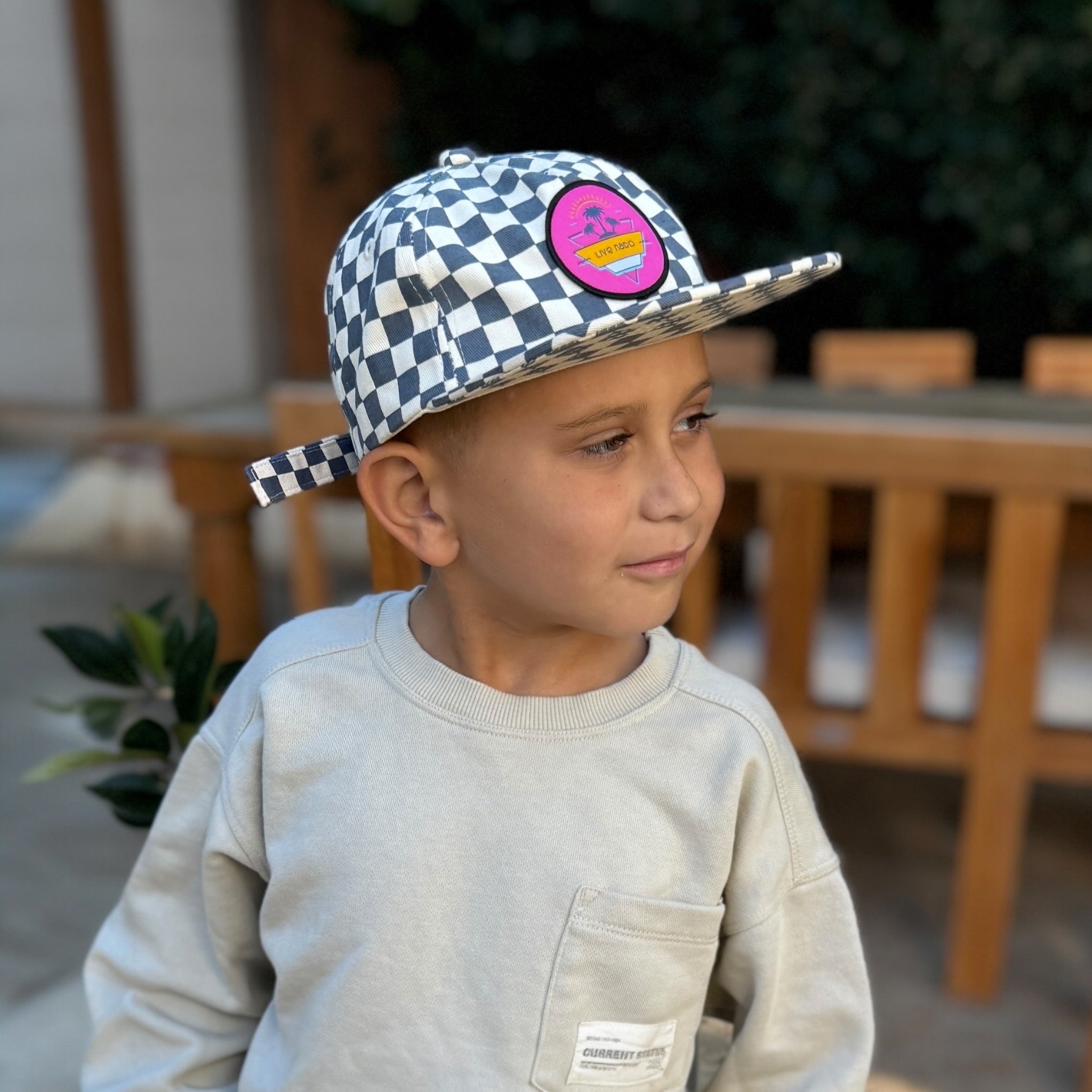 Not wearing blue checkered baseball cap with pink Live Nado patch