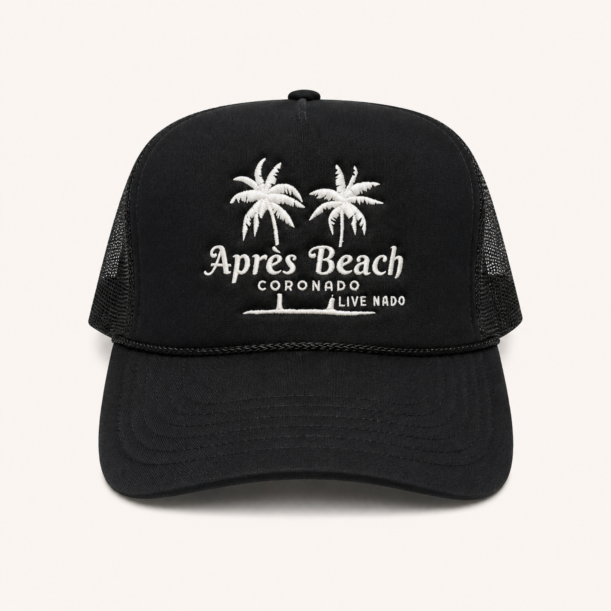 Black trucker cap with white palm tree design and text on a white background