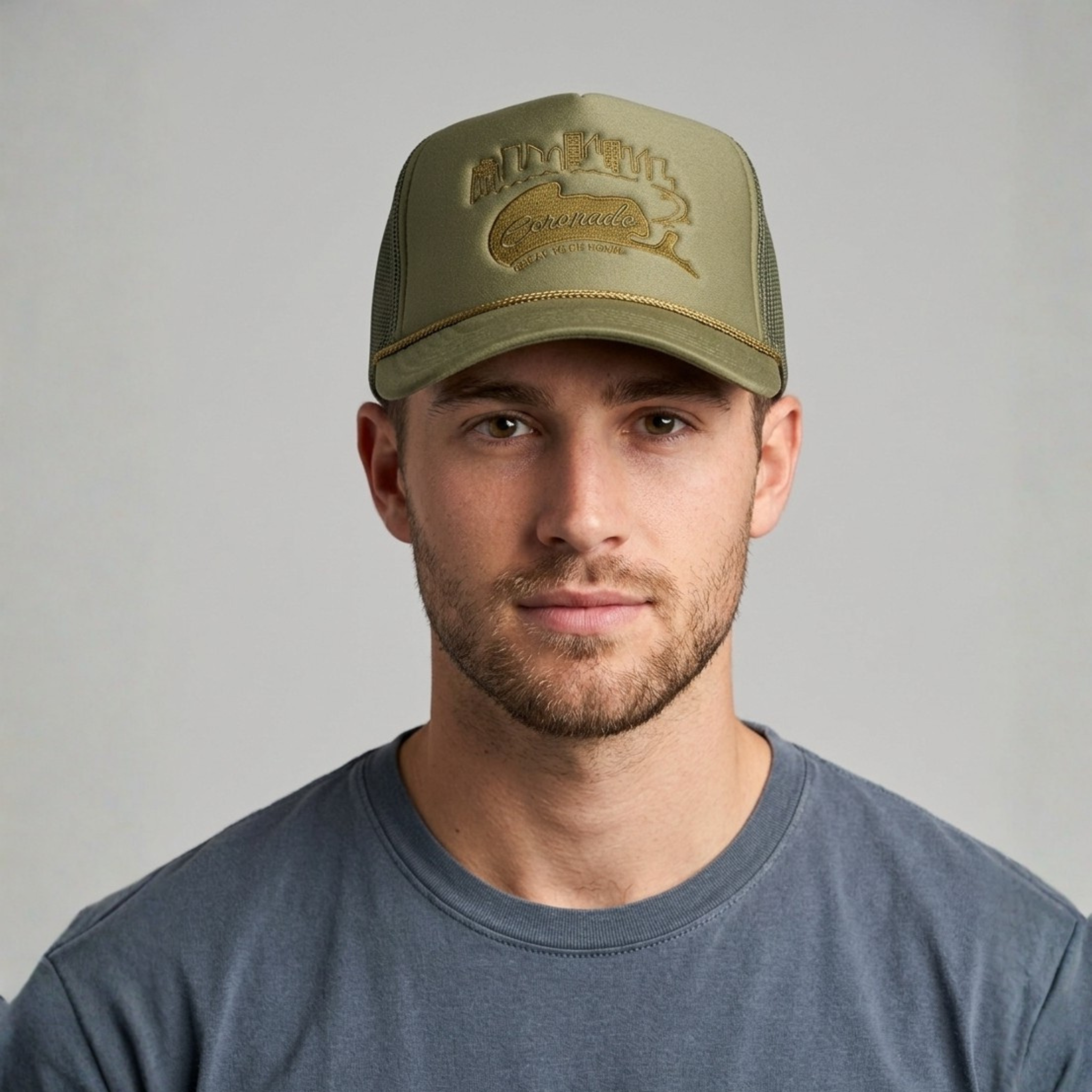 Man wearing a green cap with branding against a gray background