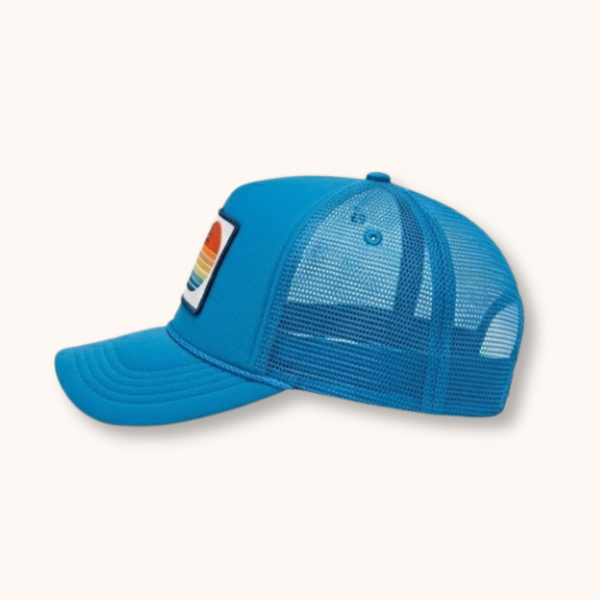 Blue mesh cap with a colorful patch on a white background