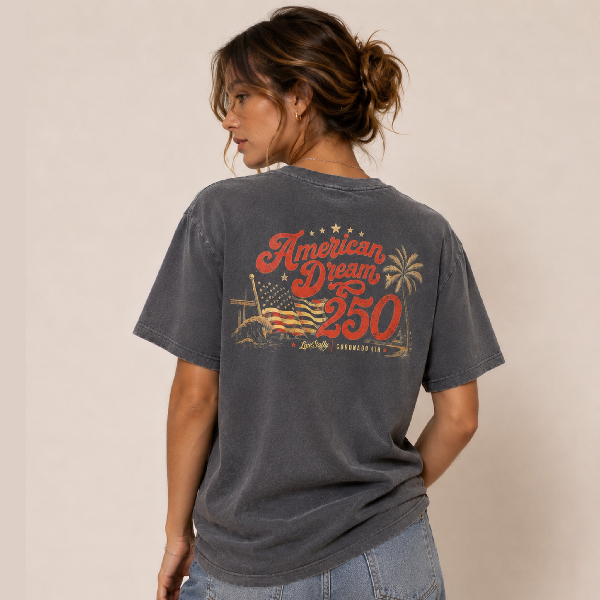 Person wearing a t-shirt with 'American Dream 250' design on the back against a beige background
