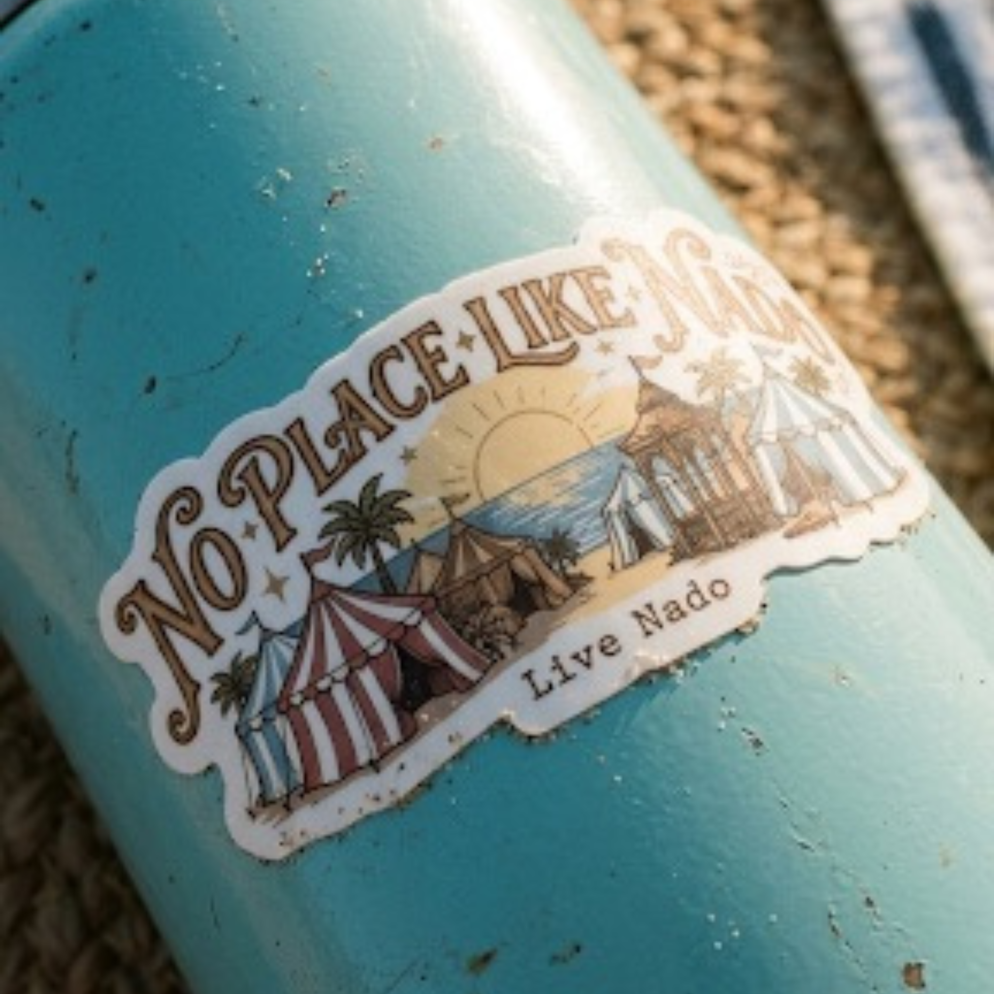 Teal bottle with 'No Place Like' sticker featuring beach scene and 'Live Nado' text.