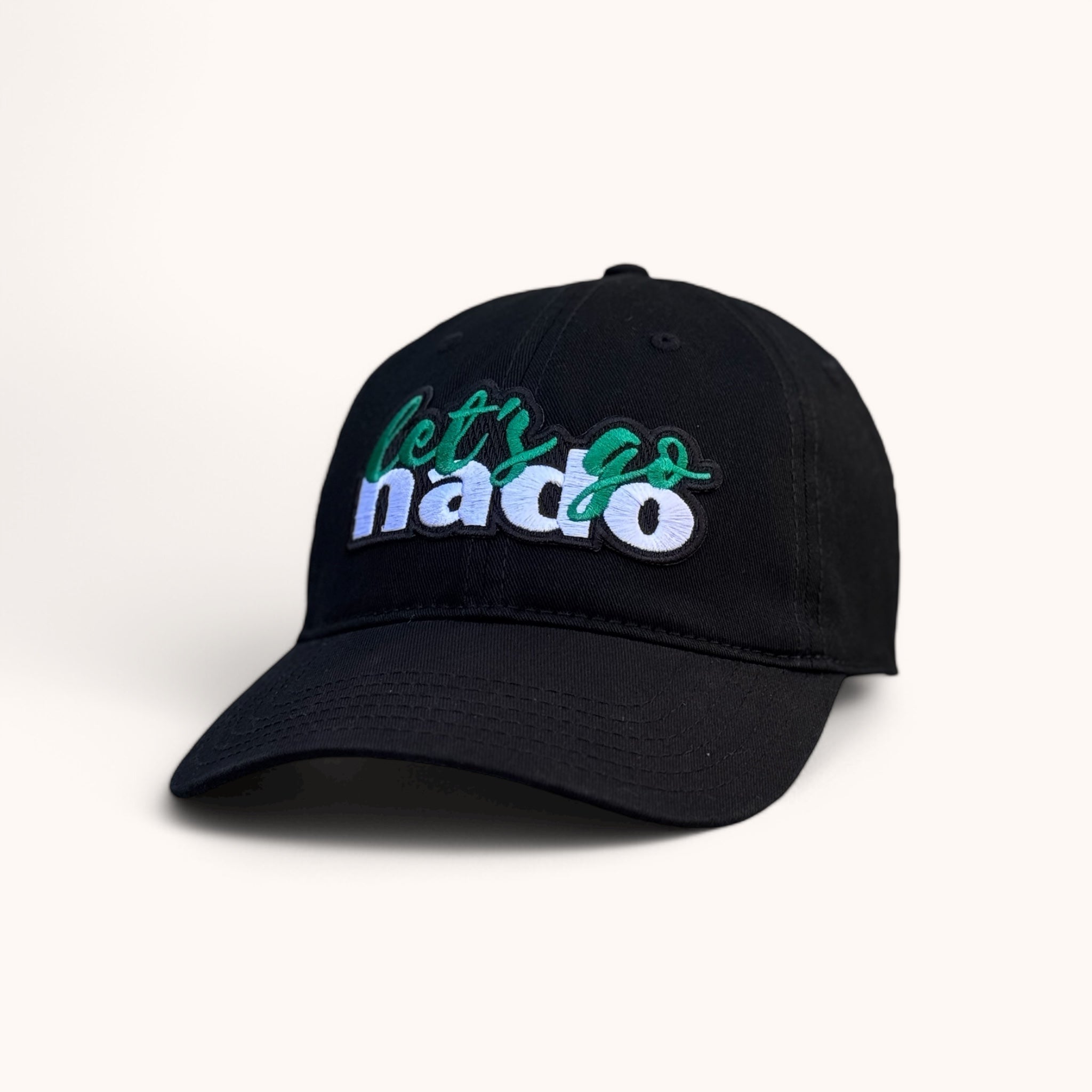 Black unstructured cotton baseball cap with a curved bill and white text that reads 'let's go nado' on the front.