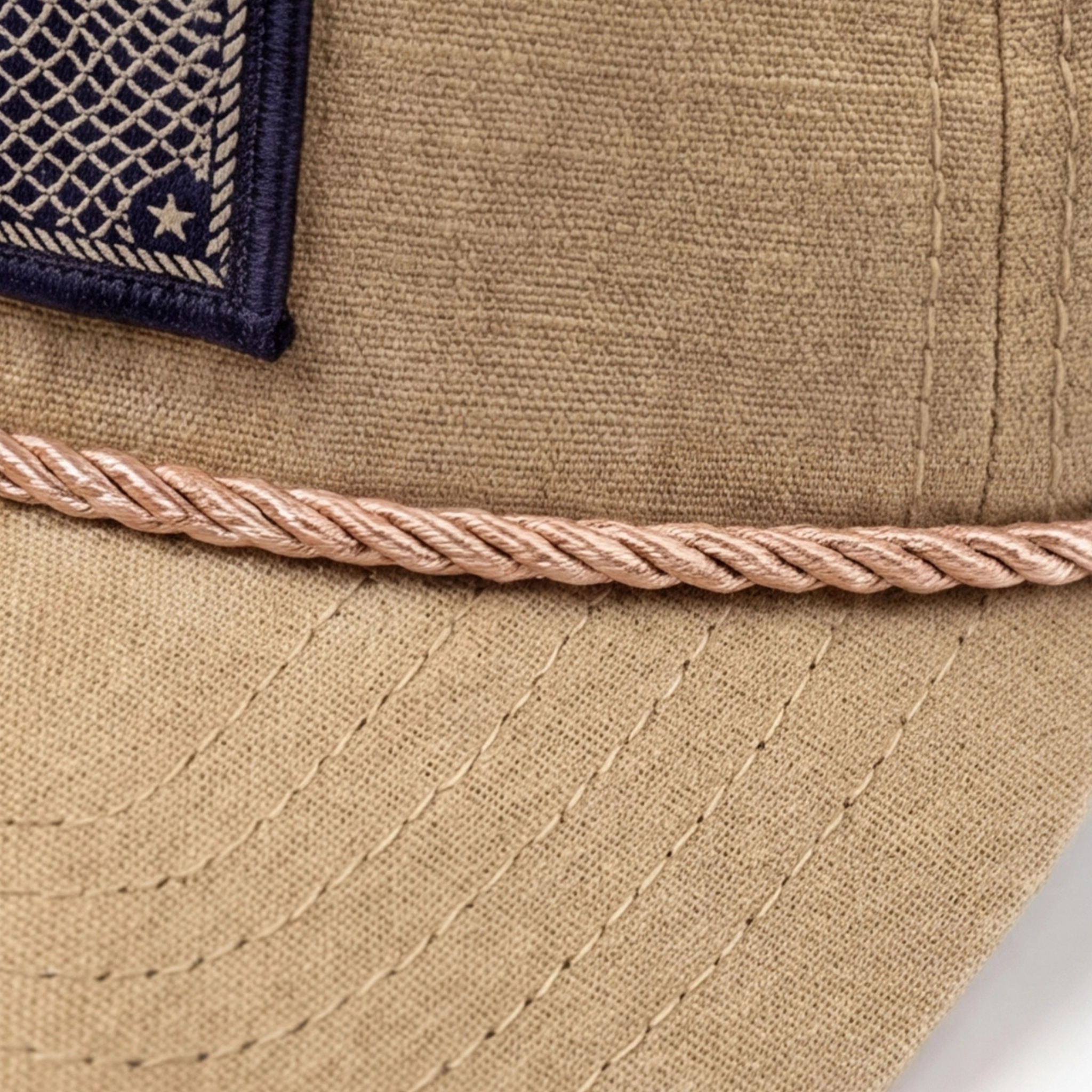 Close-up of a beige cap with an American flag patch on a white background