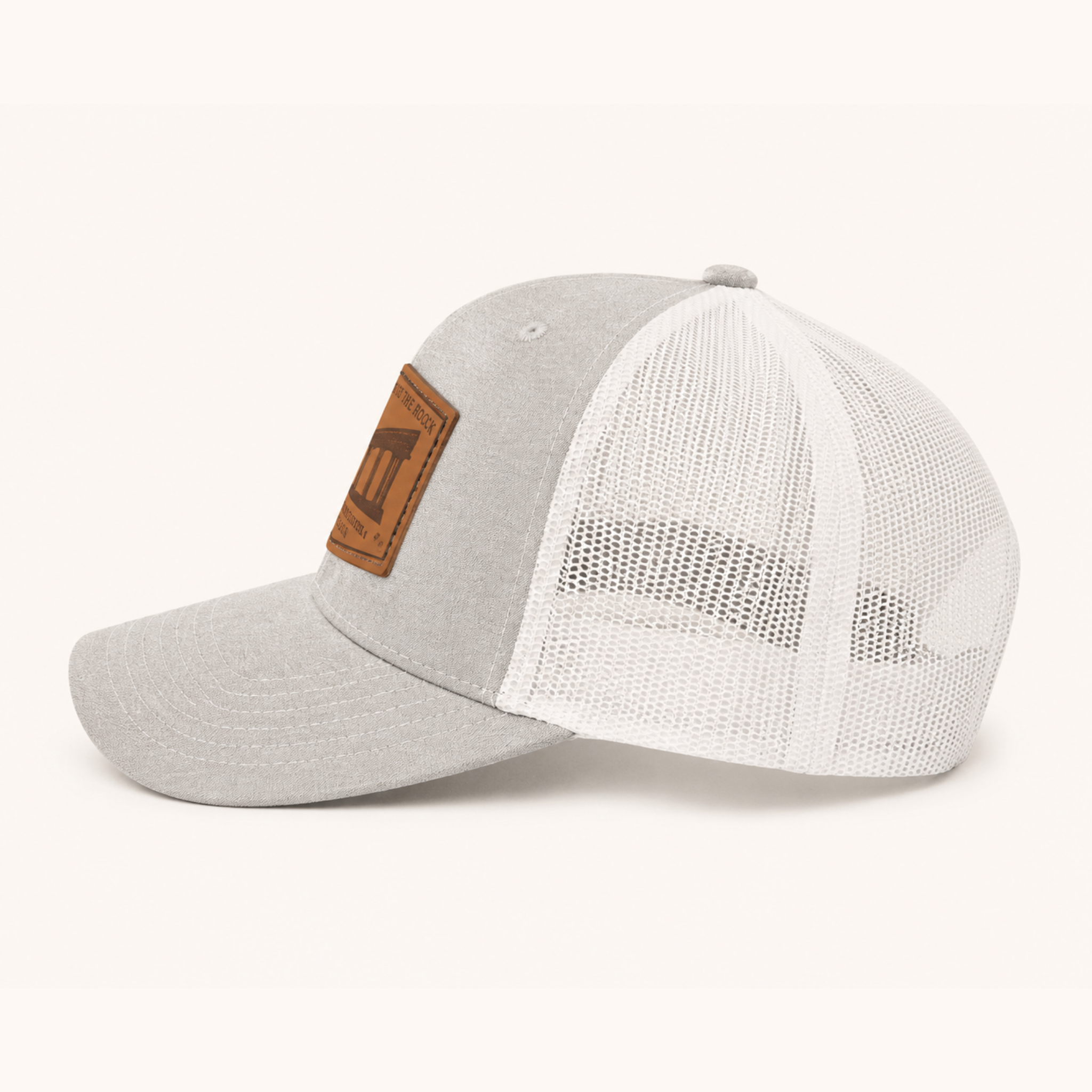 Two baseball caps, one gray and one white with a mesh back, on a white background.