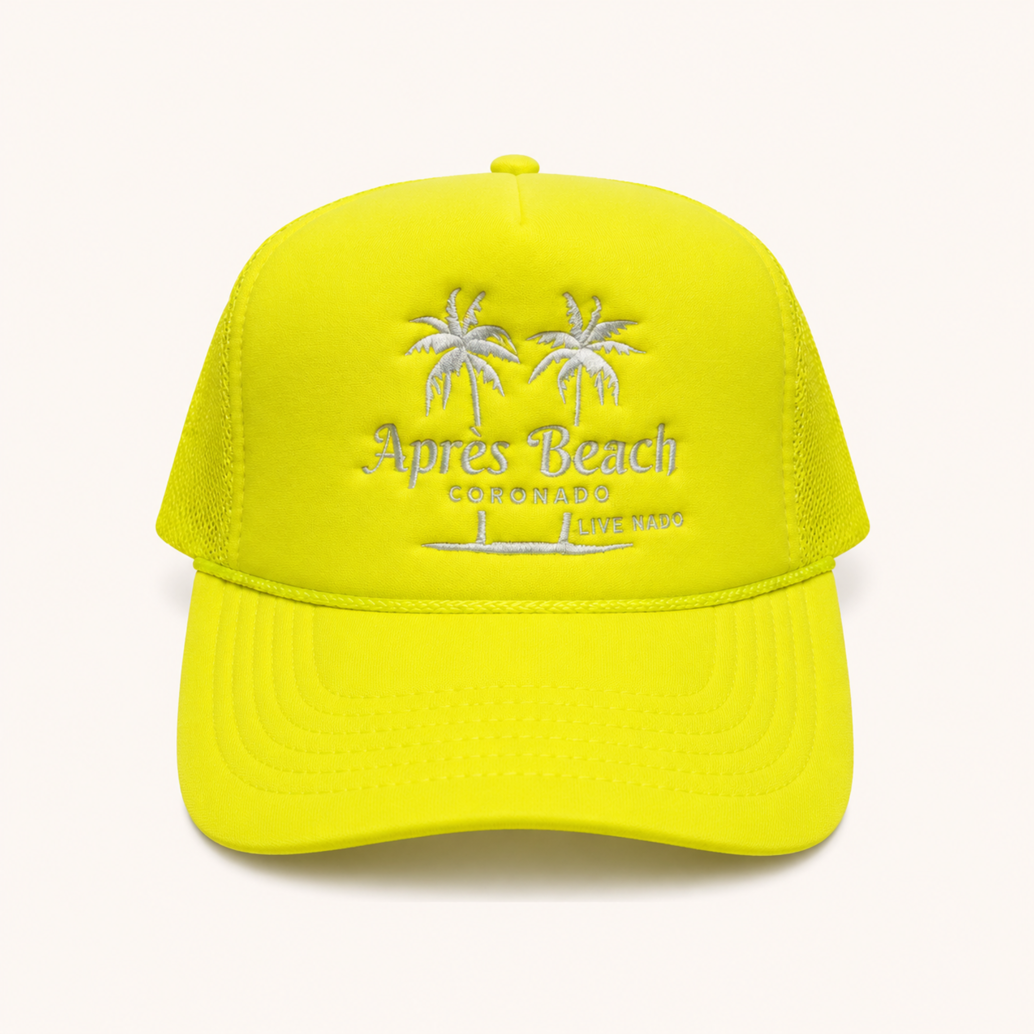 Yellow cap with 'Apres Beach' and palm tree design on a white background