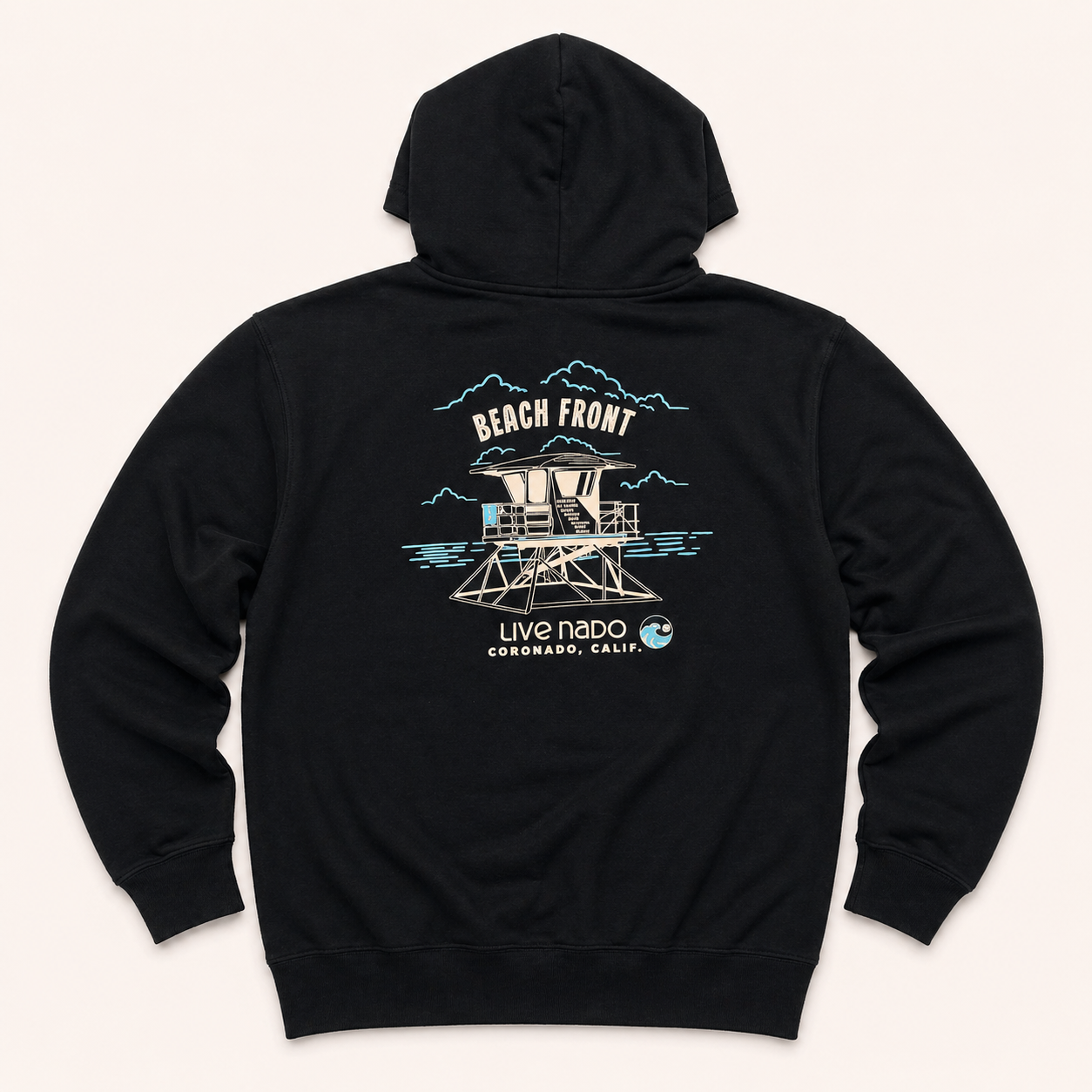 Black hoodie with a beachfront design on a light beige background
