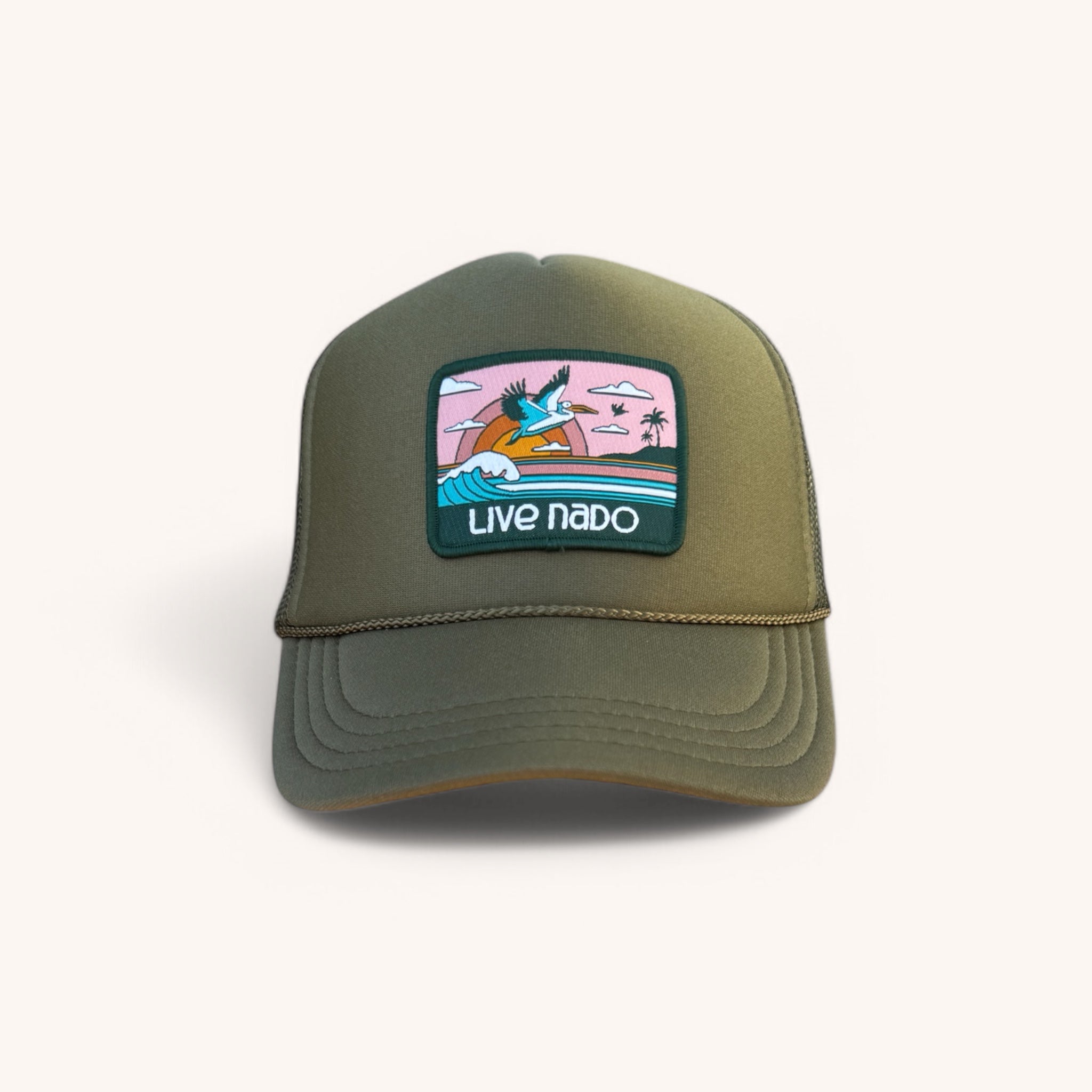 Green cap with a colorful patch featuring a surfer and 'Live Nado' text on a white background