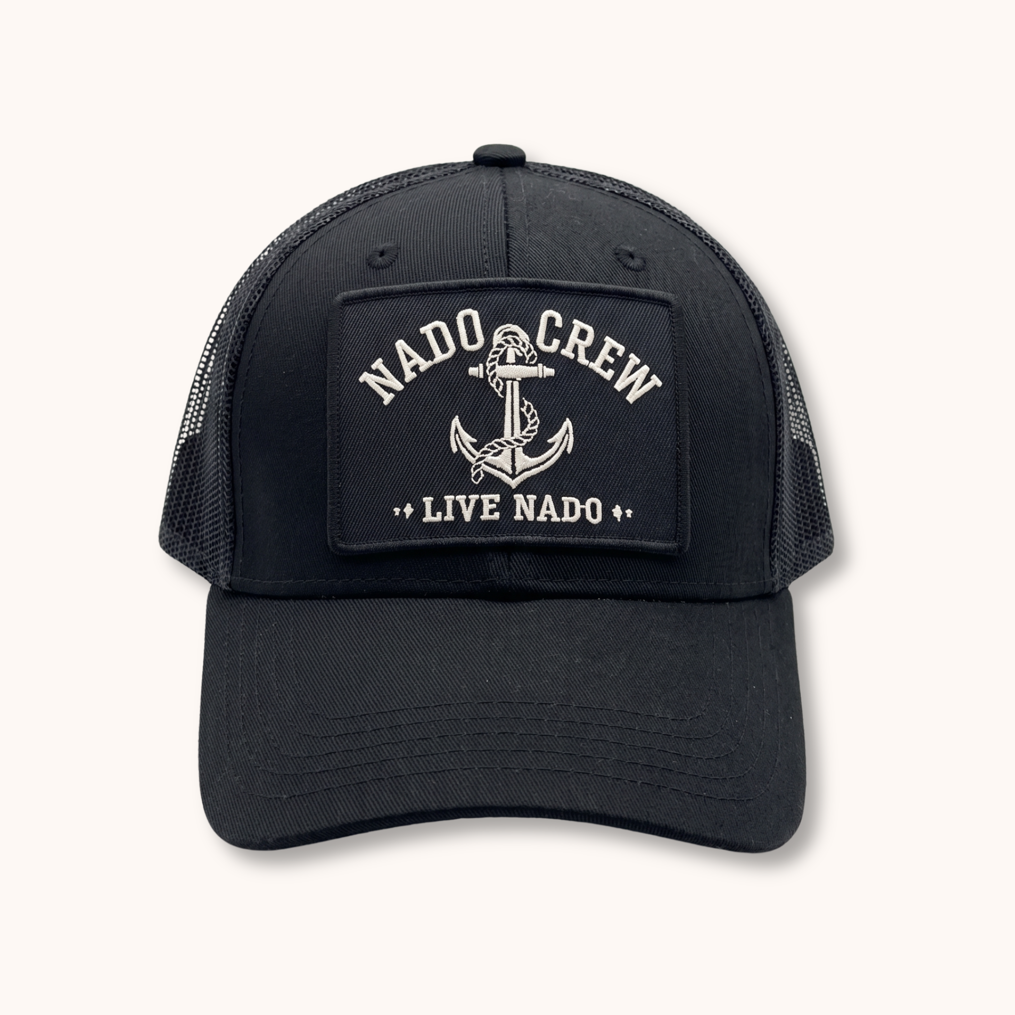 Black trucker cap with 'Nado Crew Live Nado' patch on a white background